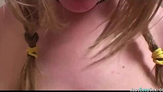 Pigtailed brunette feels pleasure playing with her big tits solo