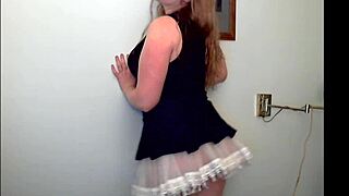 Redheaded woman performs teasing striptease