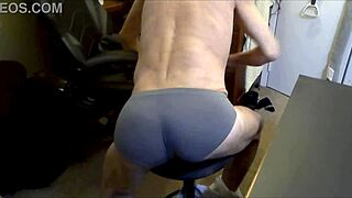I'm grinding on the stool and football in grey briefs to release muscle tension.