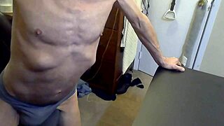 I'm grinding on the stool and football in grey briefs to release muscle tension.