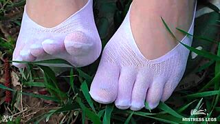Goddess Feet In Cute White Socks On Spring Grass Field