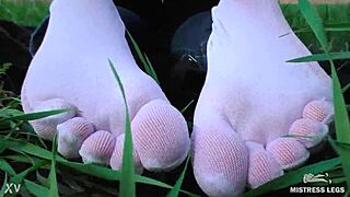 Goddess Feet In Cute White Socks On Spring Grass Field