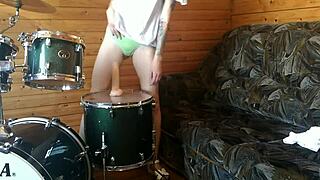 Wow, this teen is fucking her pussy with a big dildo right on the drumset!