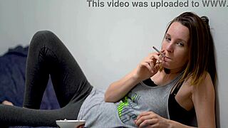 brunette babe with blue eyes smokes and teases beautifully.