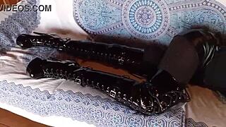 total black latex outfit hides her petite milf curves under fishnets pantyhose and knee boots