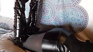 total black latex outfit hides her petite milf curves under fishnets pantyhose and knee boots