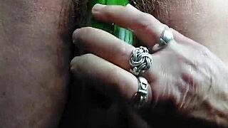 Grandma stuffs hairy pussy with thick cucumber