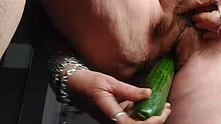 Grandma stuffs hairy pussy with thick cucumber