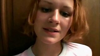 redhead poses seductively alone in the dim stairwell