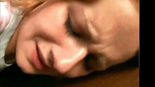 redhead poses seductively alone in the dim stairwell