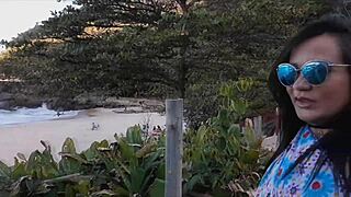 latina milf licks huge clit on beach while brunette sucks monster cock relaxing