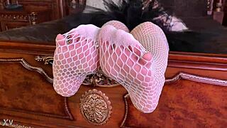 goddess teases feet in fishnets on bed driving lovers crazy