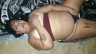 Big ass slut shakes curves and flashes pierced nipples on beach