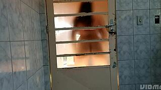 crossdresser shakes ass behind door