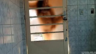 crossdresser shakes ass behind door