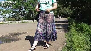 hairy mature flashes chubby pussy and fat body in see-through dress outdoors