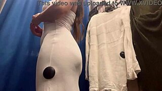 i watch this milf's big boobs bounce as she tries sexy dresses in changing room