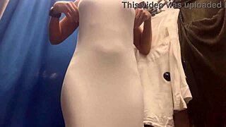 i watch this milf's big boobs bounce as she tries sexy dresses in changing room