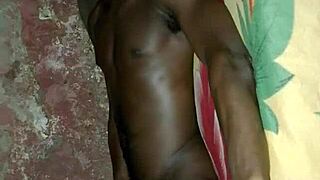 African man demonstrates solo masturbation skills on bed