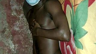 African man demonstrates solo masturbation skills on bed
