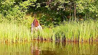 redhead stunner bares natural tits by the shimmering lake