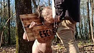 submissive milf slave locked in carcan takes uro outdoors bent over